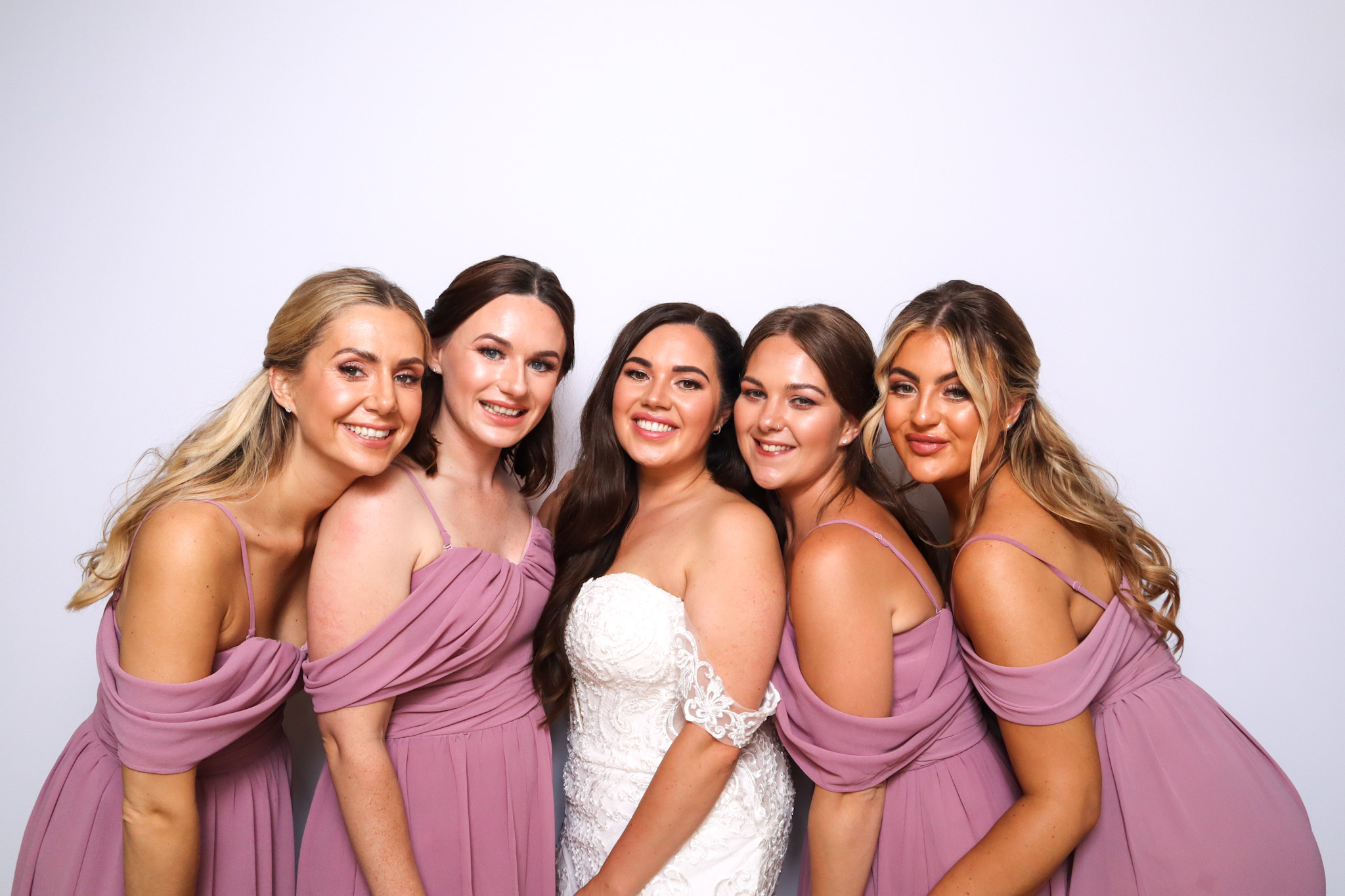 Bride & Bridesmaids posing for the photo booth at The Kingscote Barn in Gloucester