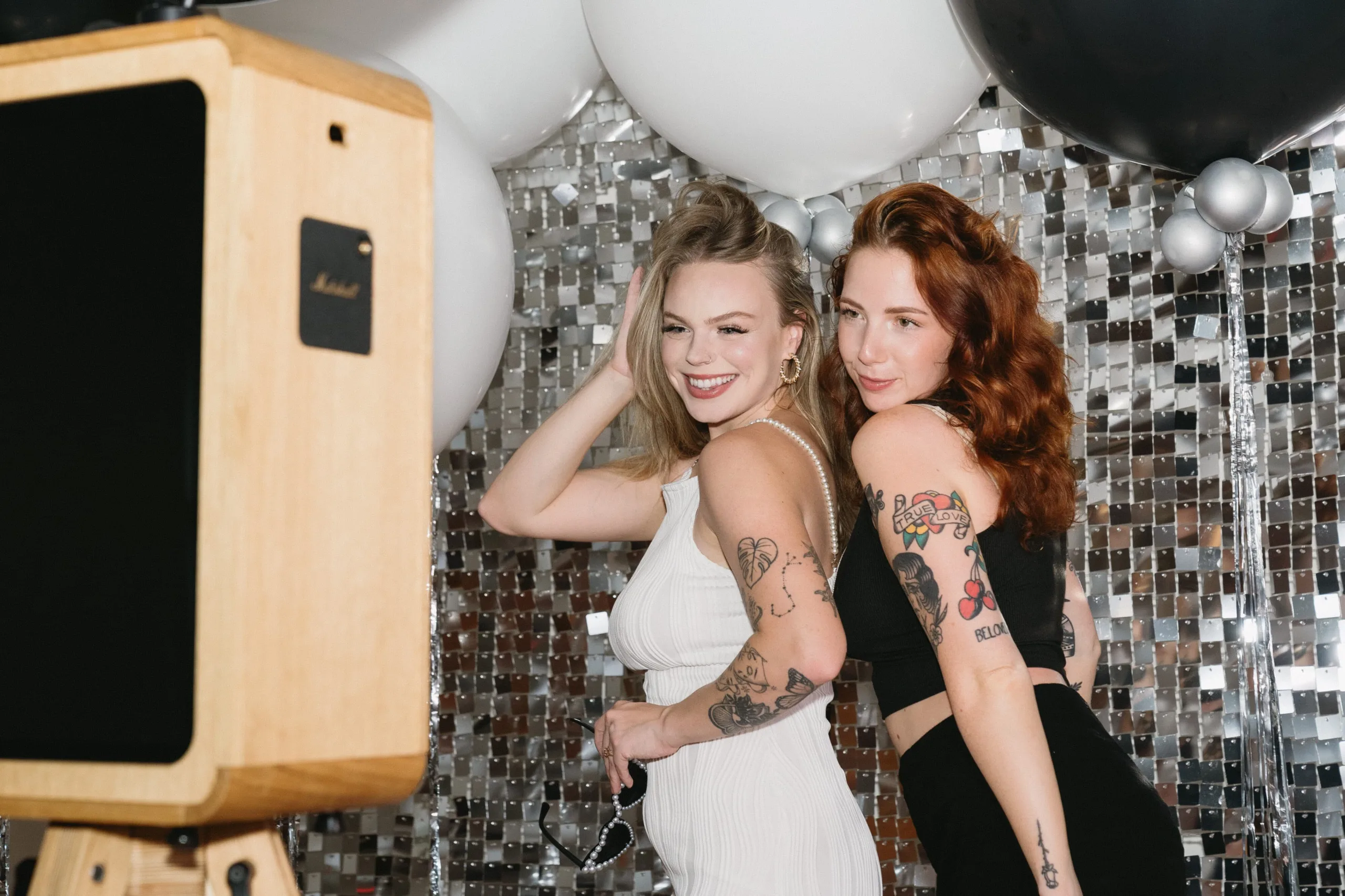 Studio Photo Booth Hire in front of a silver shimmer wall at a wedding